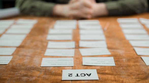 Close-up of storyboard cards arranged on a table for scriptwriting planning.